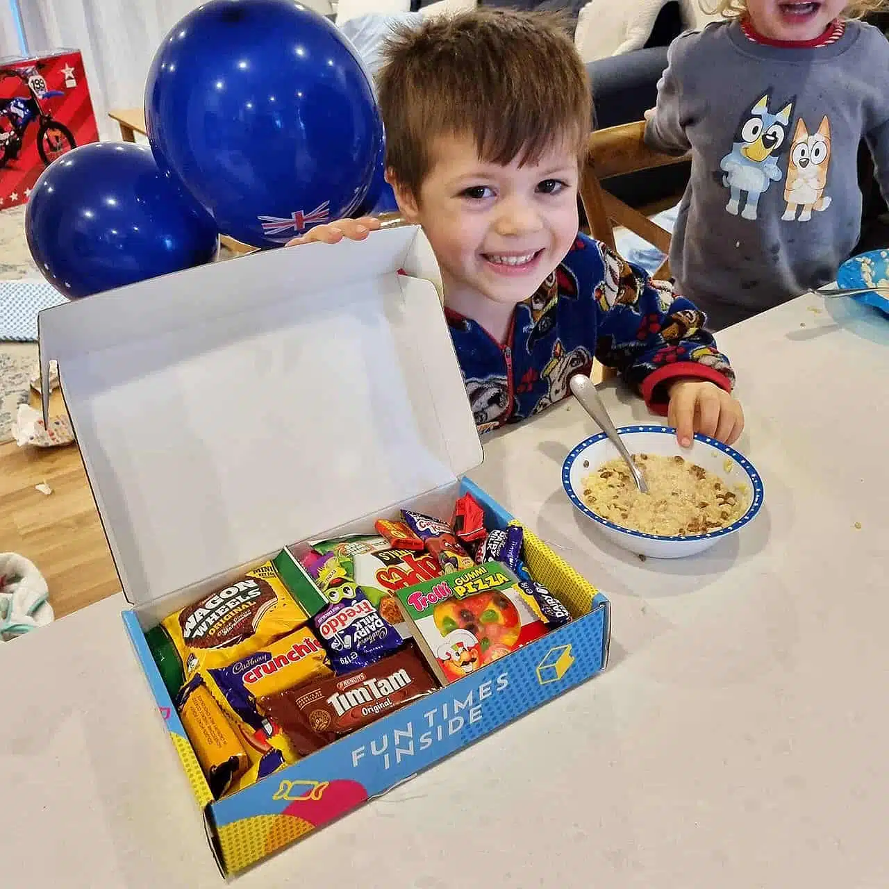 happy little boy with his snack box hamper for his birthday